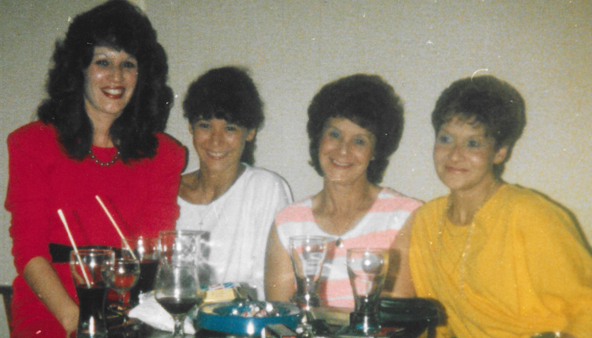 Four ladies sat at a table smiling
