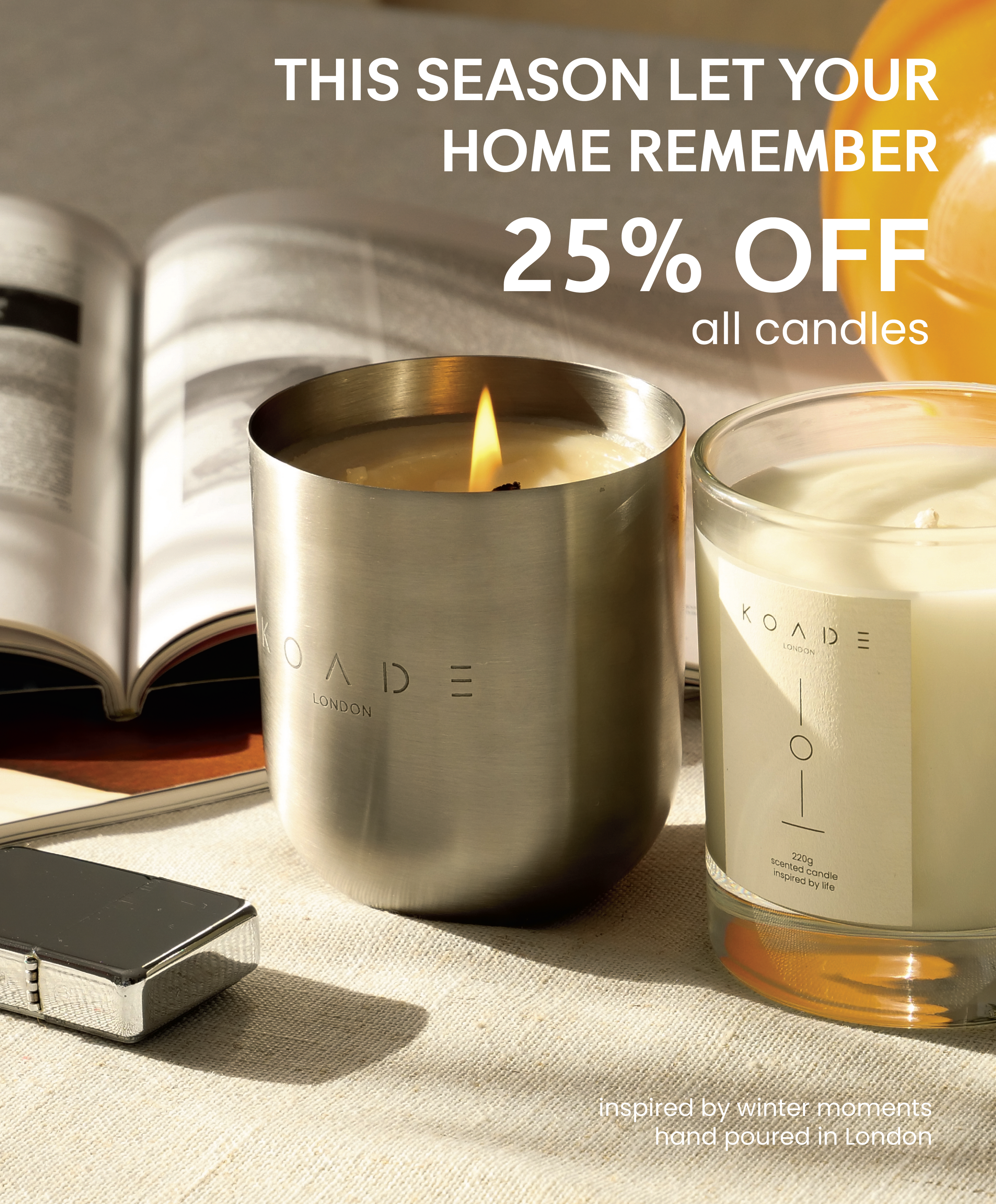 two koade scented candles on a table next to a book