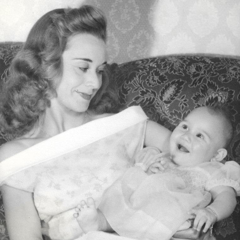 Black and white photo of a woman holding a baby