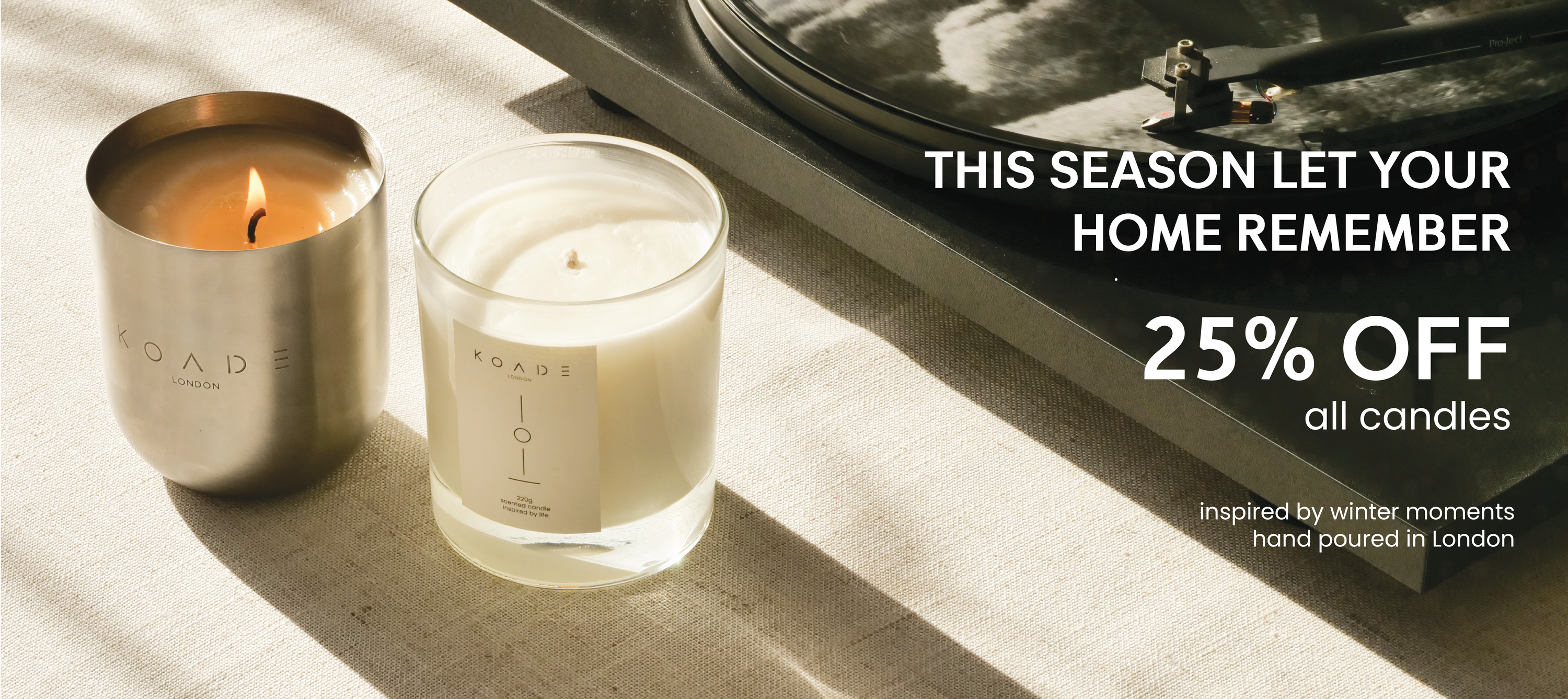 two koade candles next to a record player on a table